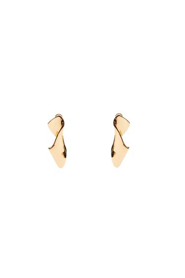 Gold earrings with an abstract, curved design on a white background.
