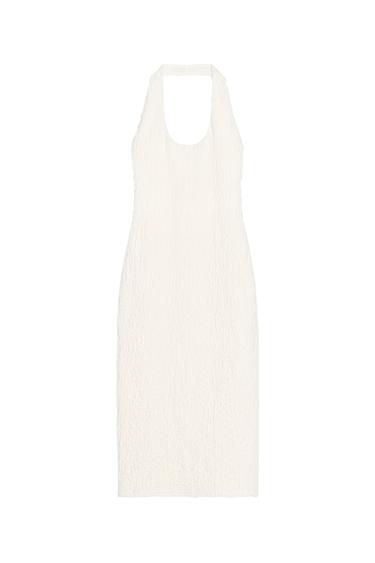 Front view of a sleeveless white dress with a halter neck and crinkled texture.