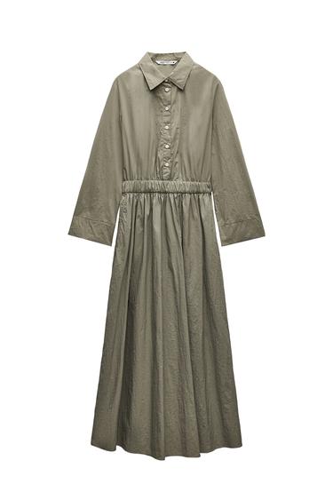 Front view of an olive green maxi dress with a classic collar, button-down front, and elasticated waist.
