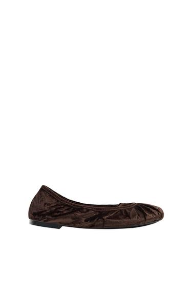 Dark brown velvet flat ballerina shoe with gathered detailing at the toe, shown in profile against a white background.