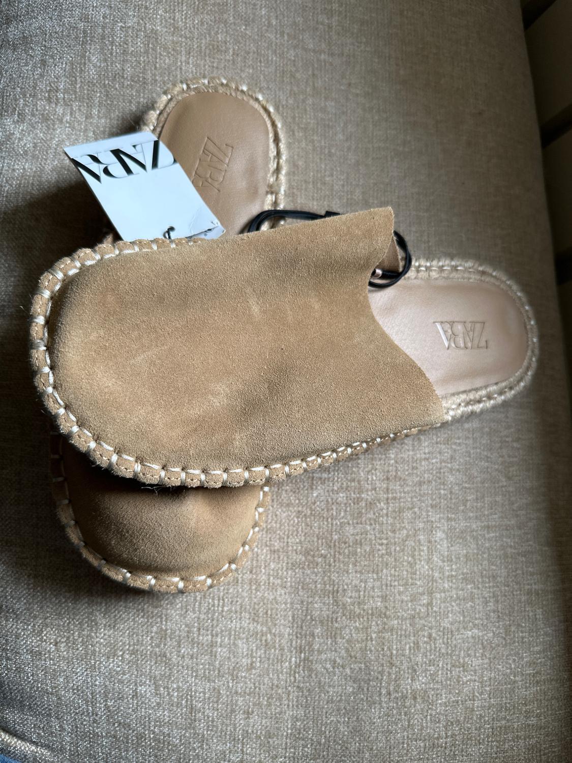 Beige suede slingback shoes with white stitching and braided trim on fabric. ZARA text on label and insole.