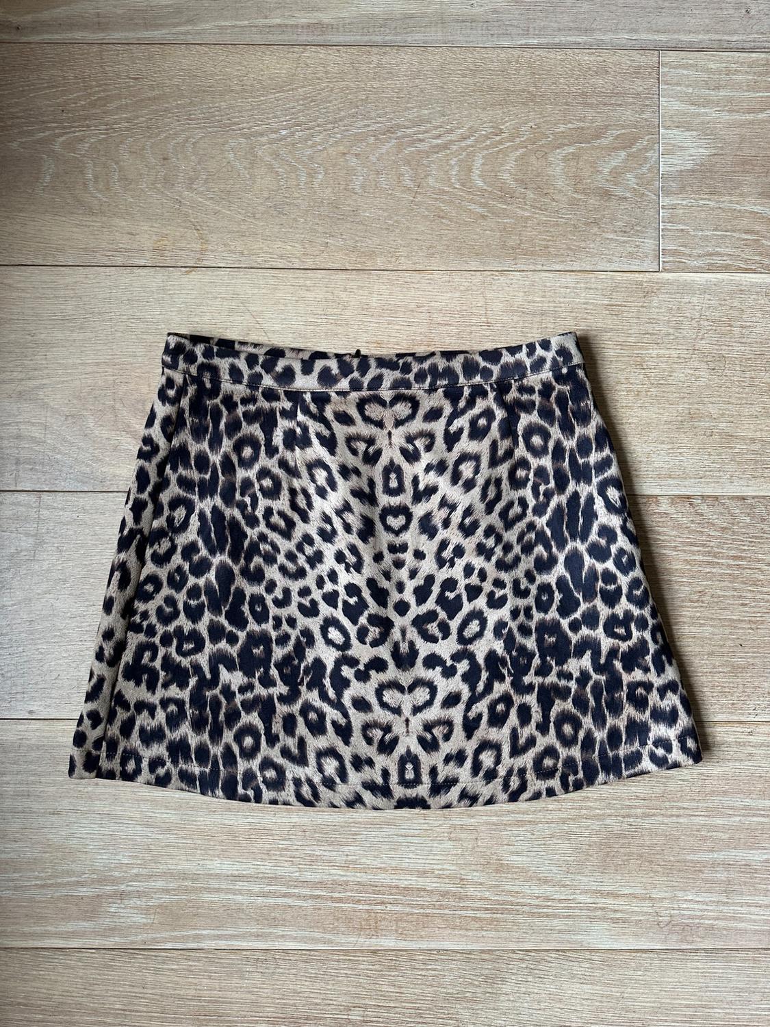 Front view of a short skirt with a brown and black leopard print.