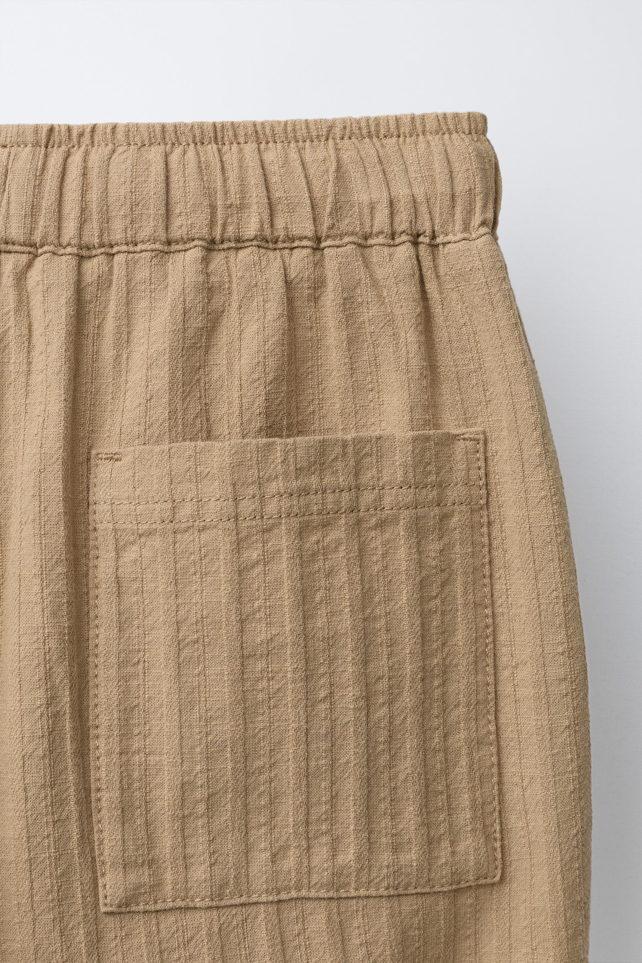 STRAIGHT TEXTURED PLEATED PANTS