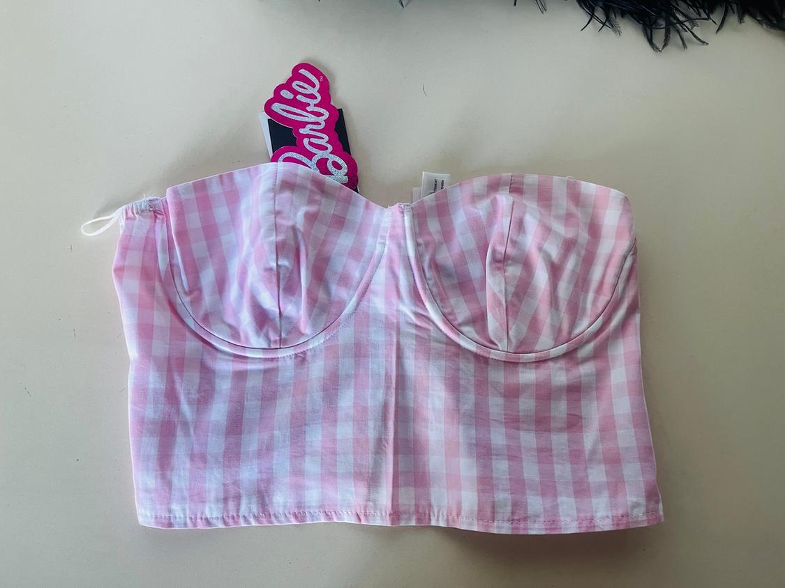 Pink and white checked top with "Barbie" label on a light background.