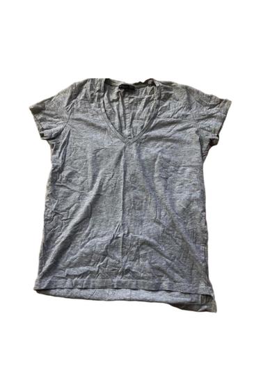 Light gray short-sleeve V-neck basic t-shirt, with a wrinkled texture, laid flat on a white background.