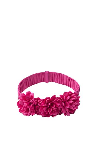 Front view of a pink headband with decorative flowers.