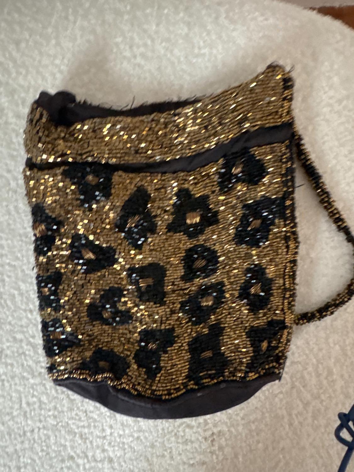 Front view of a bag with gold and black sequins in an animal print.