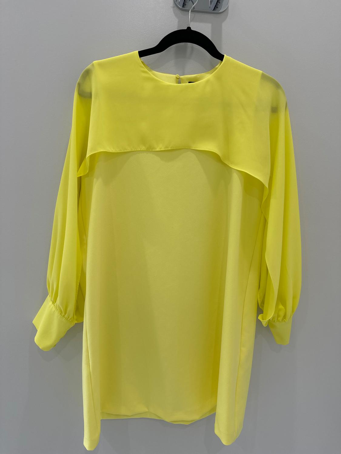 Front view of a yellow blouse with long puffed sleeves and a short top layer.
