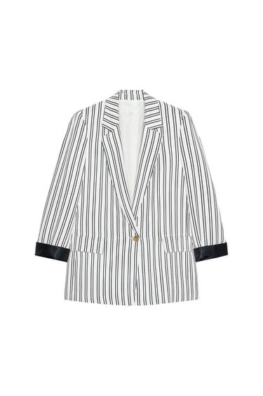 Front view of a black and white striped blazer with lapel and side pockets.