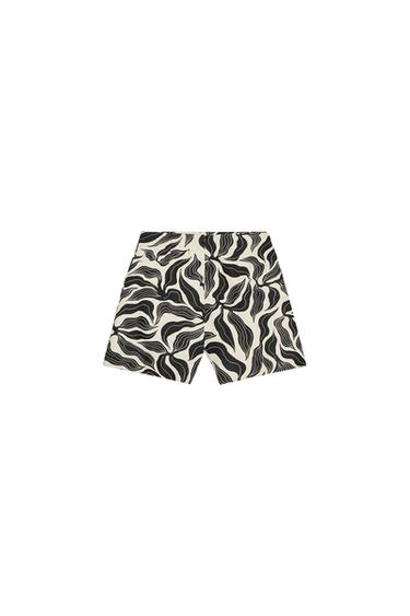 Rear view of black and white abstract print shorts.