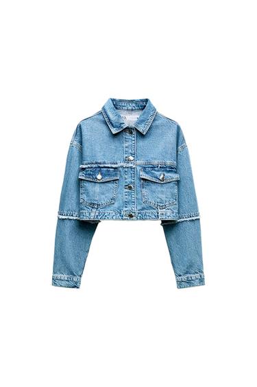 Front view of a short blue denim jacket with front flap pockets and metal buttons.