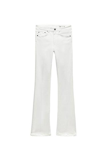 White flared jeans with five pockets on a white background. Interior label with the text ZARA.
