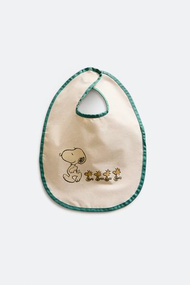 CHILDREN'S PEANUTS™ RESIN-COATED BIB - Cream by Zara