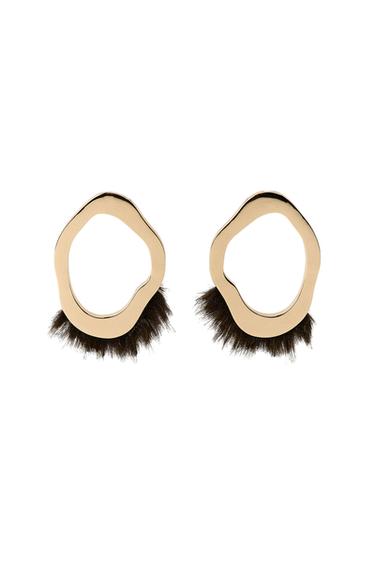 Front view of gold earrings with irregular edge and furry brown details.
