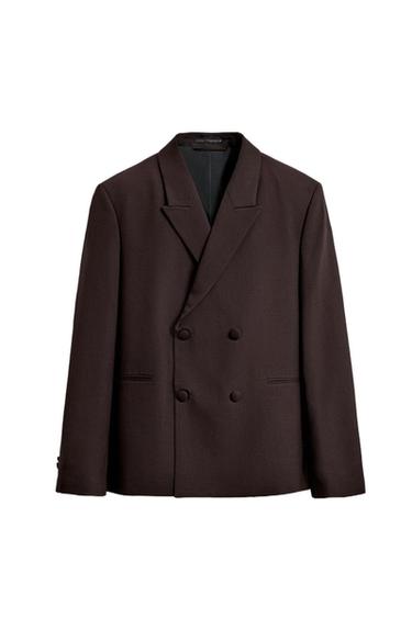 Dark brown cross-body blazer with peak lapels, four buttons, and front pockets on a white background.