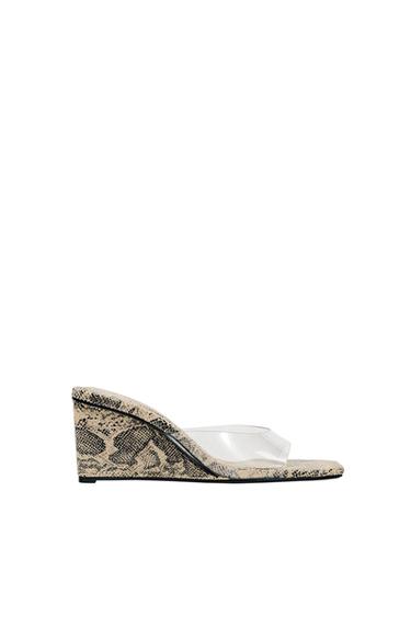 Snake-print wedge sandal with transparent strap, side view on white background.