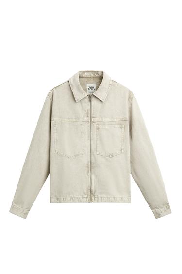 Front view of beige jacket with front pockets and zip fastening.