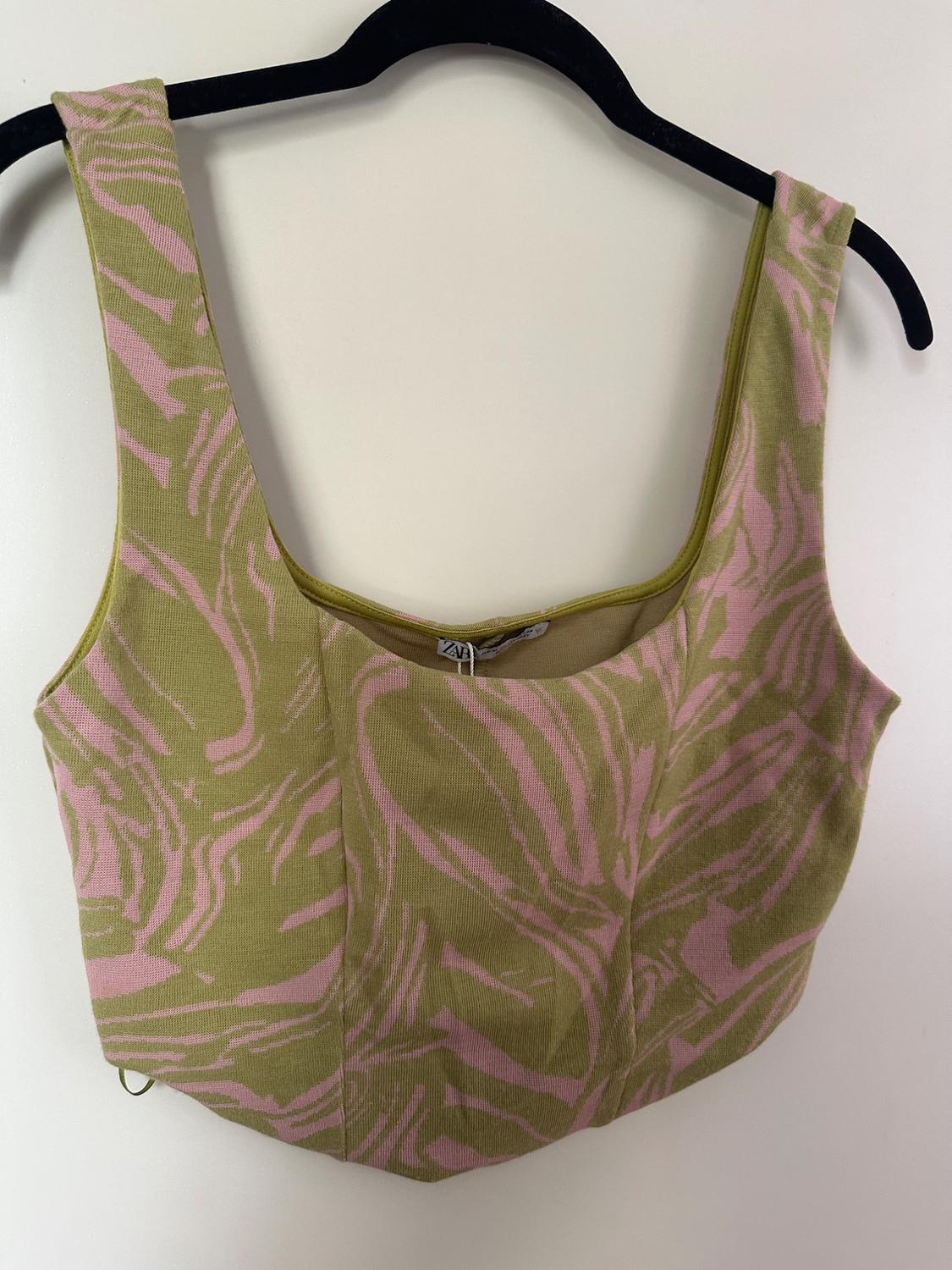 Green cropped top with a pointed hem, pink abstract print, square neckline, and wide straps on a black hanger. ZARA label visible.