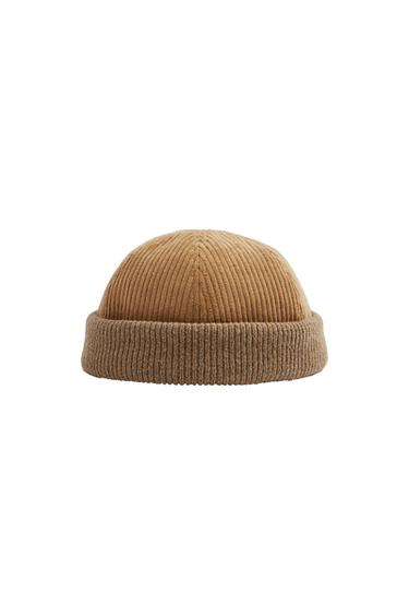 Docker-style hat with a camel-coloured corduroy crown and a brown ribbed knitted turn-up brim, on a white background.