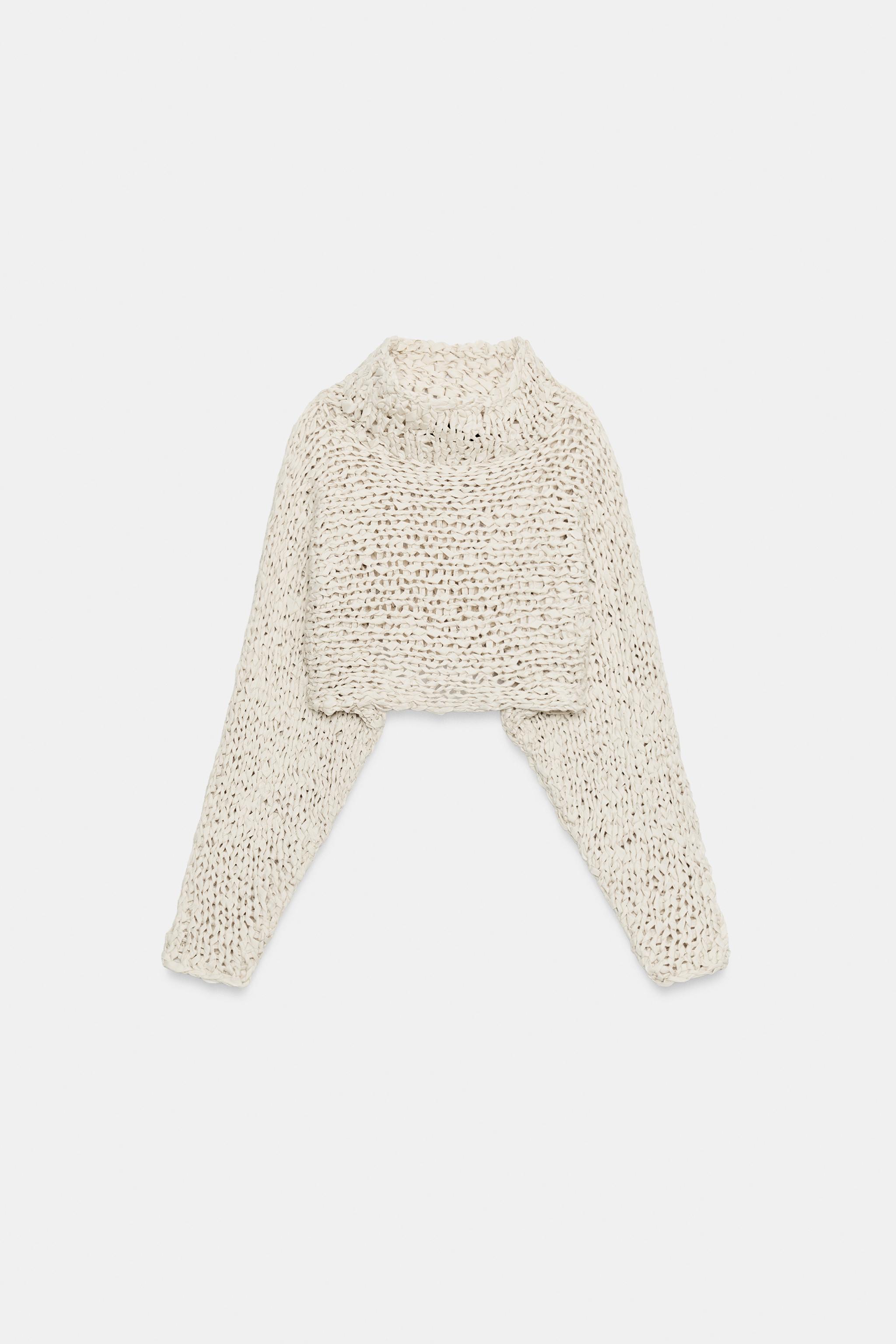 PULL COURT EN MAILLE À BANDE ENTRELAÇÉE