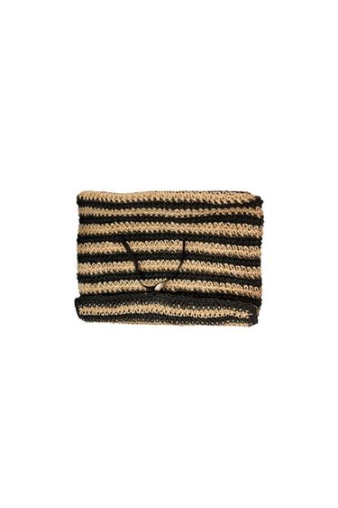 Front view of a black and beige striped knitted bag with a drawstring closure.