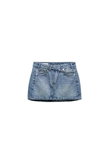 Front view of a blue denim mini skirt with front pockets and belt loops.