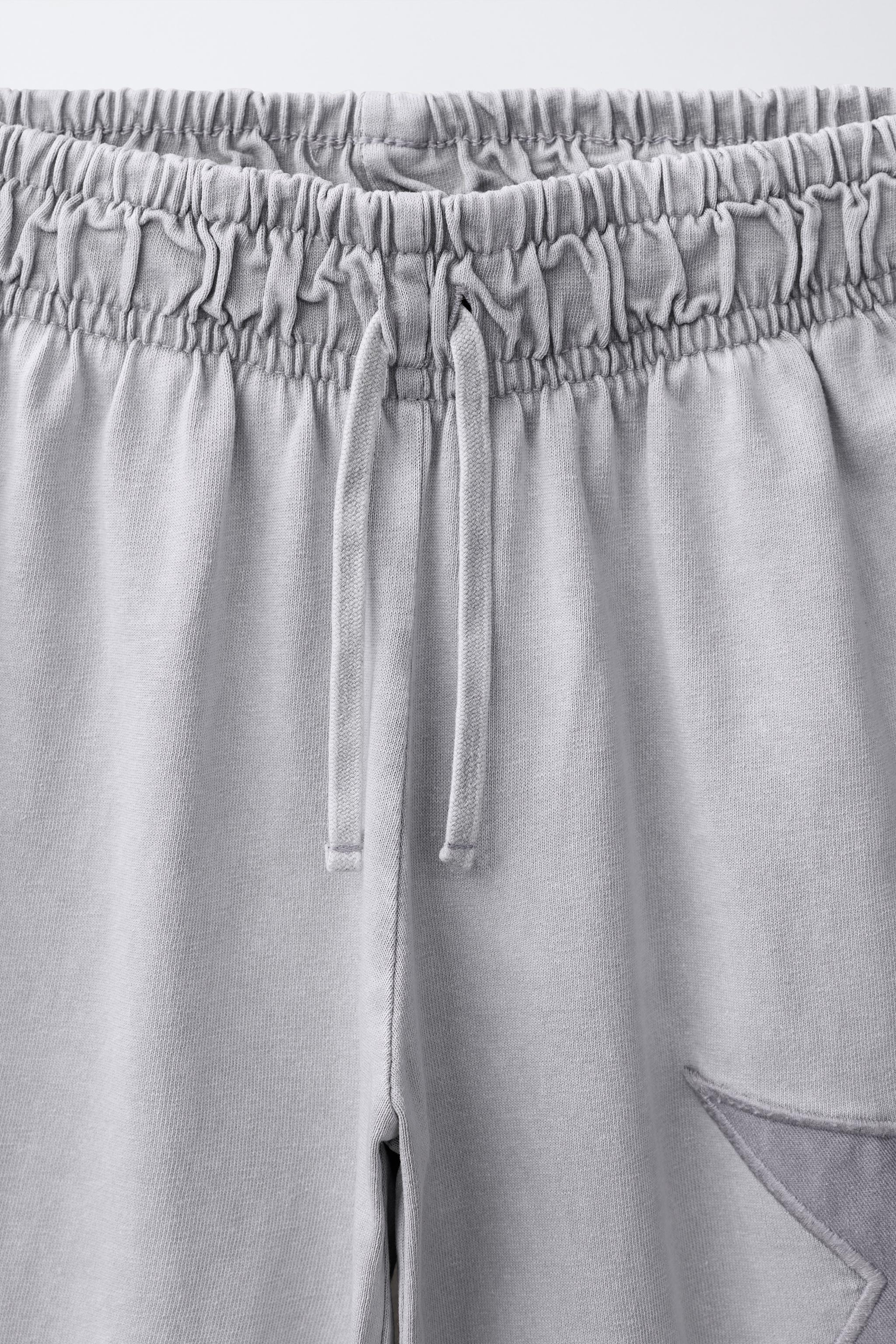 WASHED EFFECT STAR WIDE LEG PANTS