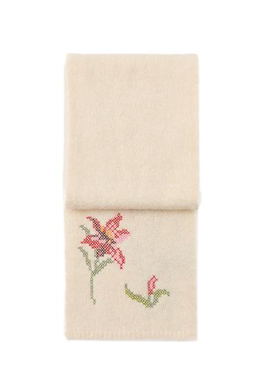 Front view of raw scarf with floral embroidery in red and green.