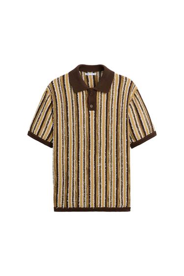 Brown, beige, and white vertical striped polo shirt with brown collar and cuffs. Buttons down the front. White background.
