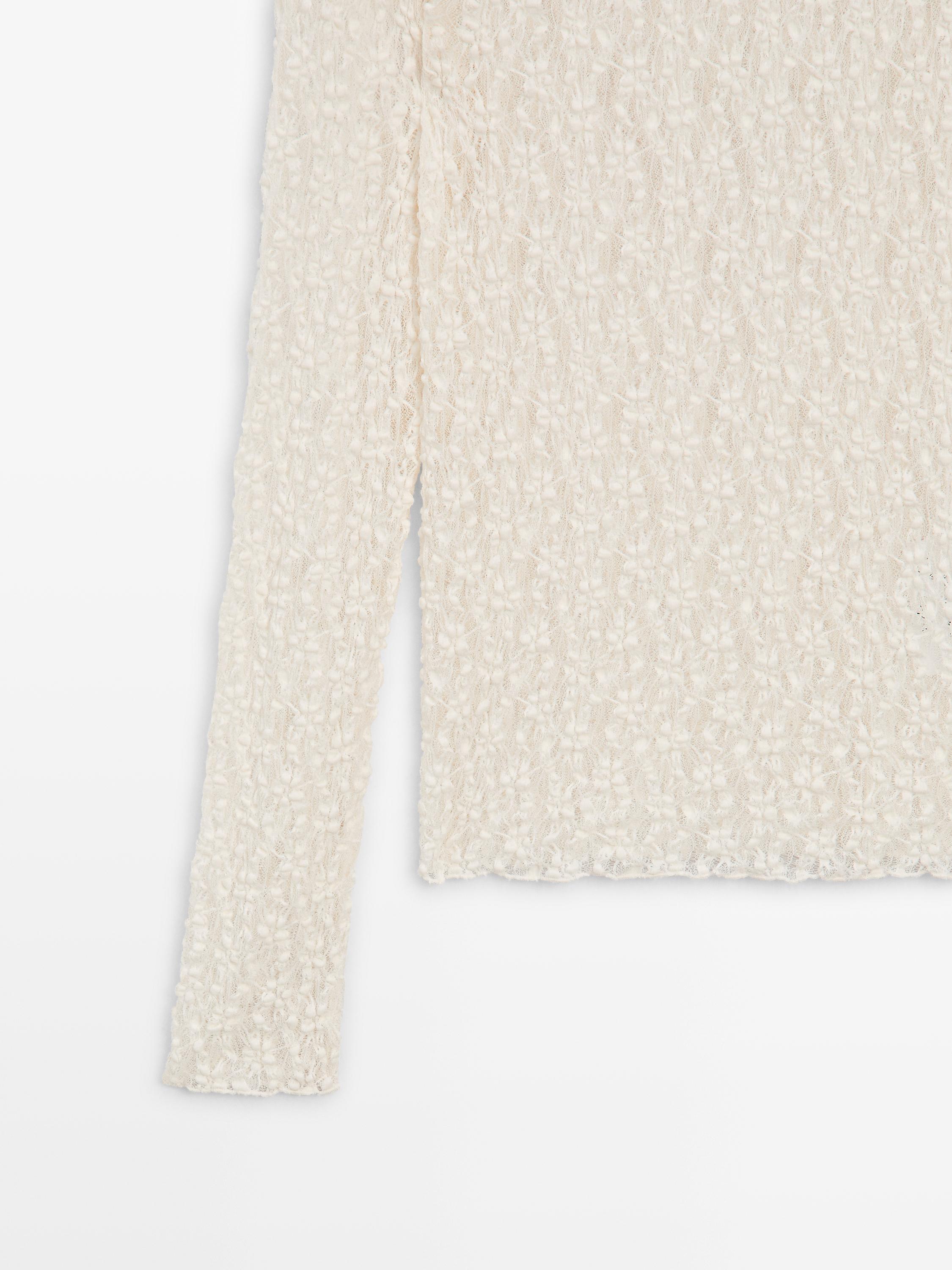 Openwork knit top with long sleeves and lace