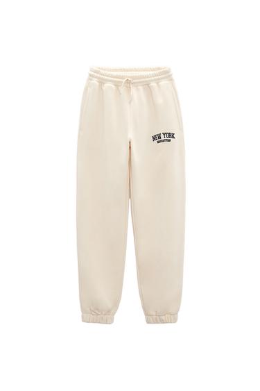 JOGGING TROUSERS WITH EMBROIDERED SLOGAN