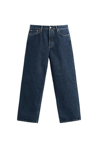 Front view of dark blue jeans with front pockets and button fastening.
