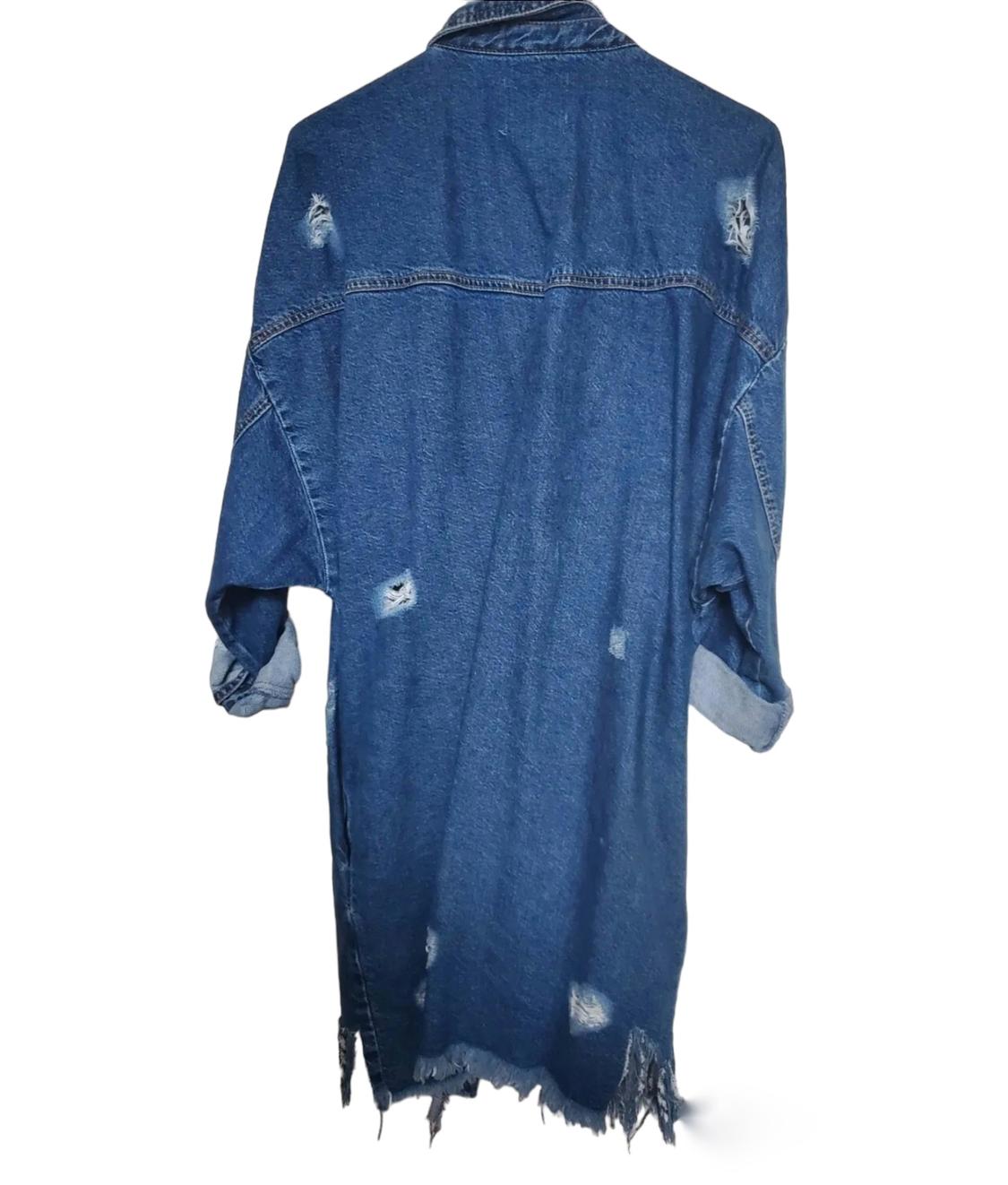 Rear view of blue denim jacket with distressed details and frayed hem.