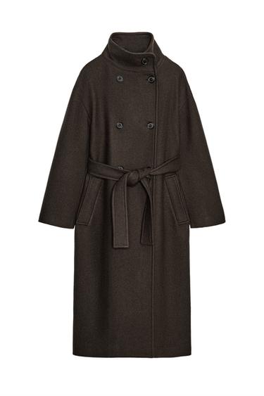 Front view of an oversized chocolate coat with a funnel neck, long sleeves, double-breasted button fastening and front pockets.