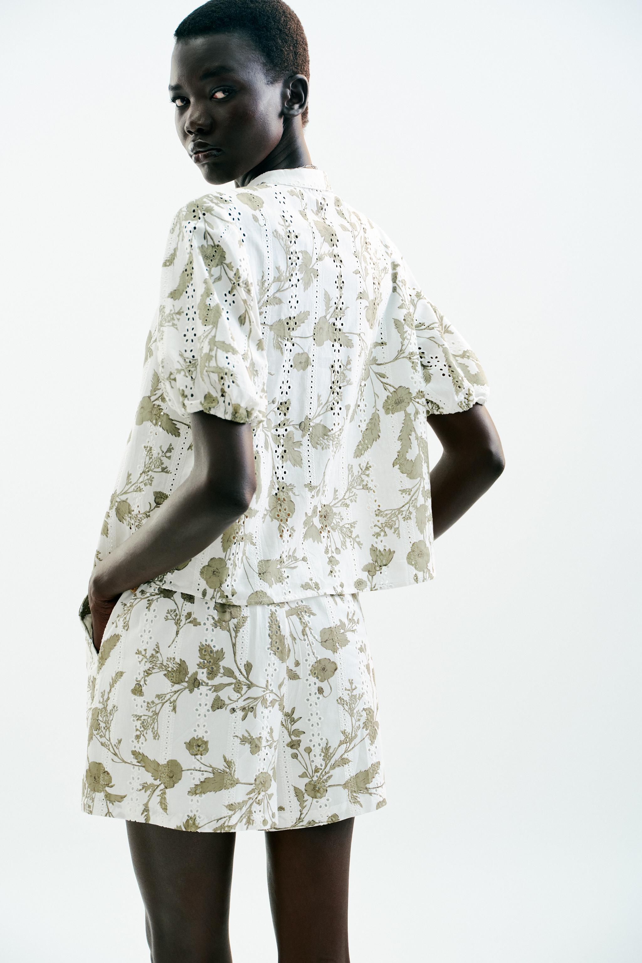 PRINTED TOP WITH EMBROIDERED EYELETS