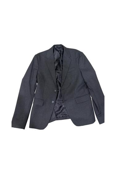 Dark grey blazer on a white background. It features notched lapels, a two-button front fastening and flap pockets.