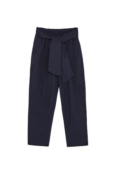 Front view of blue trousers with a belt tied at the waist and a straight cut.