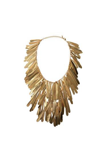 Gold-tone necklace with multiple elongated feather-shaped pendants, layered on a white background.