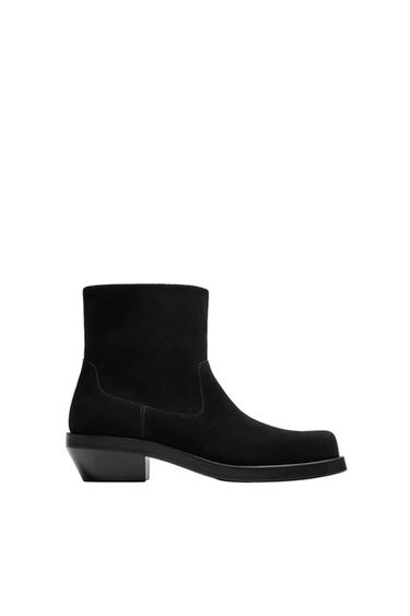 Side view of black cowboy style boot with side zip, square toe and sole with slight heel. Smooth upper.