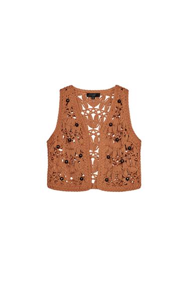 Front view of a knitted brown waistcoat with decorative buttons.