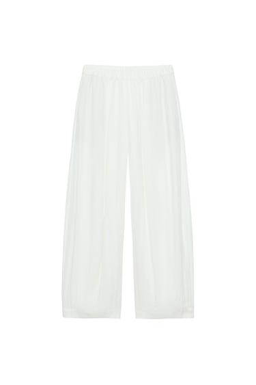 Front view of trousers with an elasticated waist and concealed side pockets.