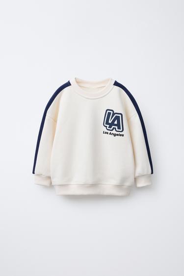 SUDADERA ESTAMPADA VARSITY - Crudo / Marino de Zara - Imagen 0