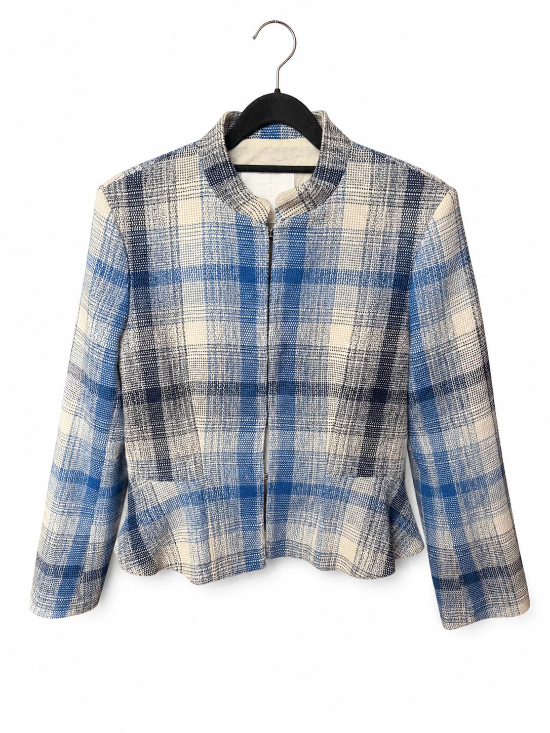 Textured blue and white checked jacket, with a high neck, zip fastening and flared hem. Hanging on a black hanger against a white background.