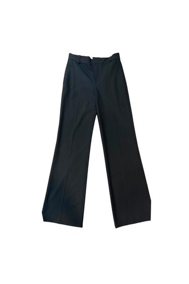 Black wide-leg pants on a white background, with front pleats and zipper closure.