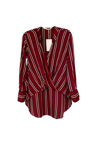Vertical striped blouse in red, white, and black with a wrap design and visible tag in the center. White background.