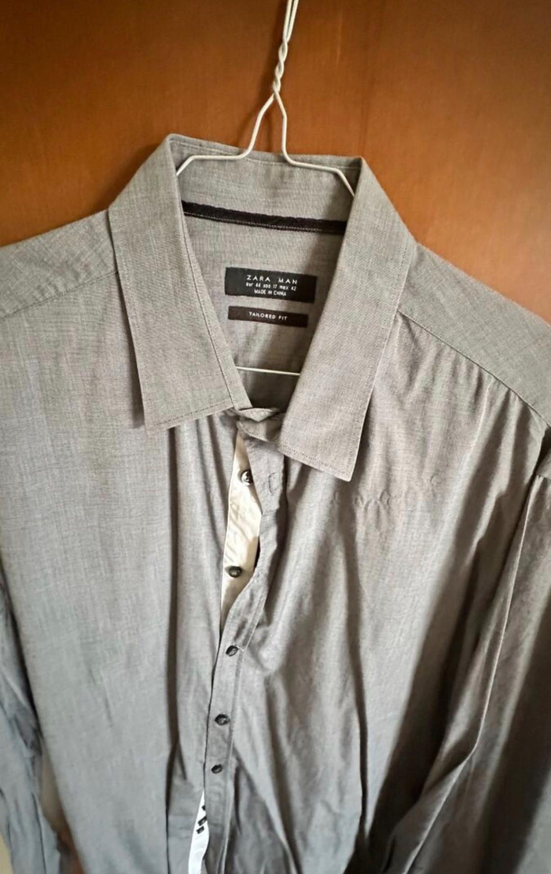 Men's grey shirt hanging on a hanger, with a visible label that reads "ZARA MAN, TAILORED FIT, MADE IN CHINA".