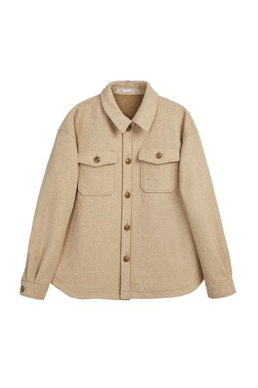 Front view of beige shirt with large brown buttoned front flap pockets.
