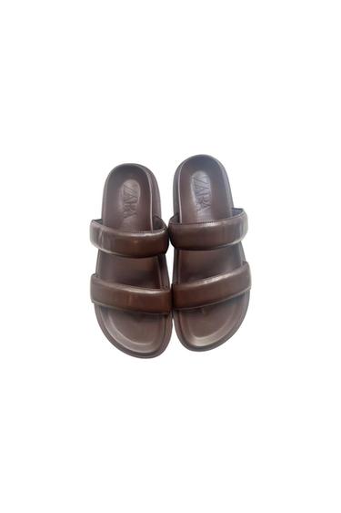 Brown double-strap sandals with 'ZARA' embossed on the insole, on a white background.