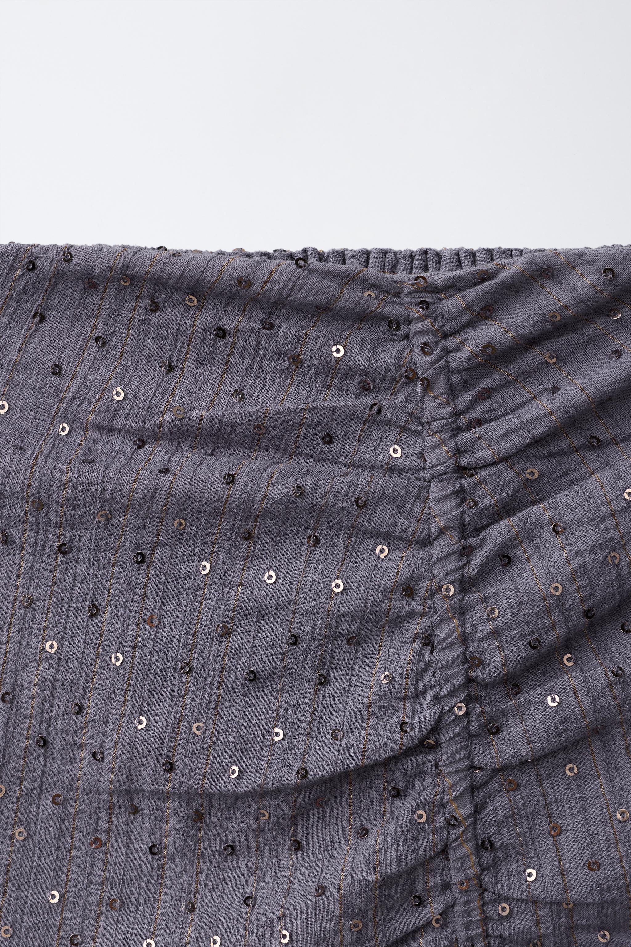 JUPE DRAPÉE À PAILLETTES