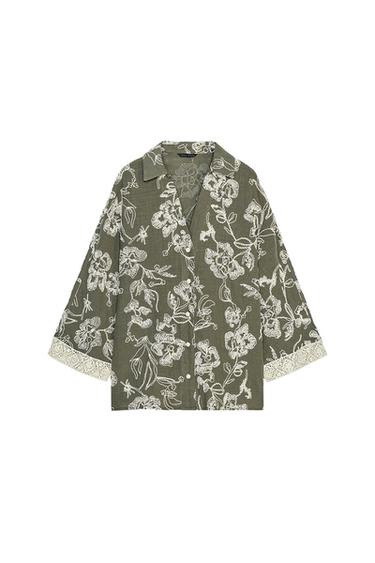 Front view of a green shirt with white floral print and long sleeves.
